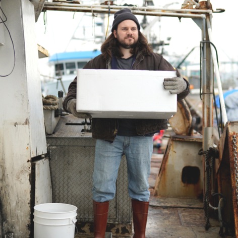 Man carrying supplies on a fishing boat