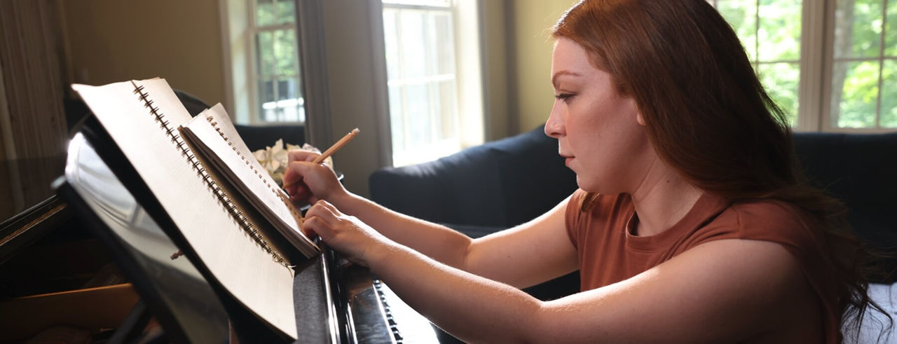 Portrait of a woman writing music